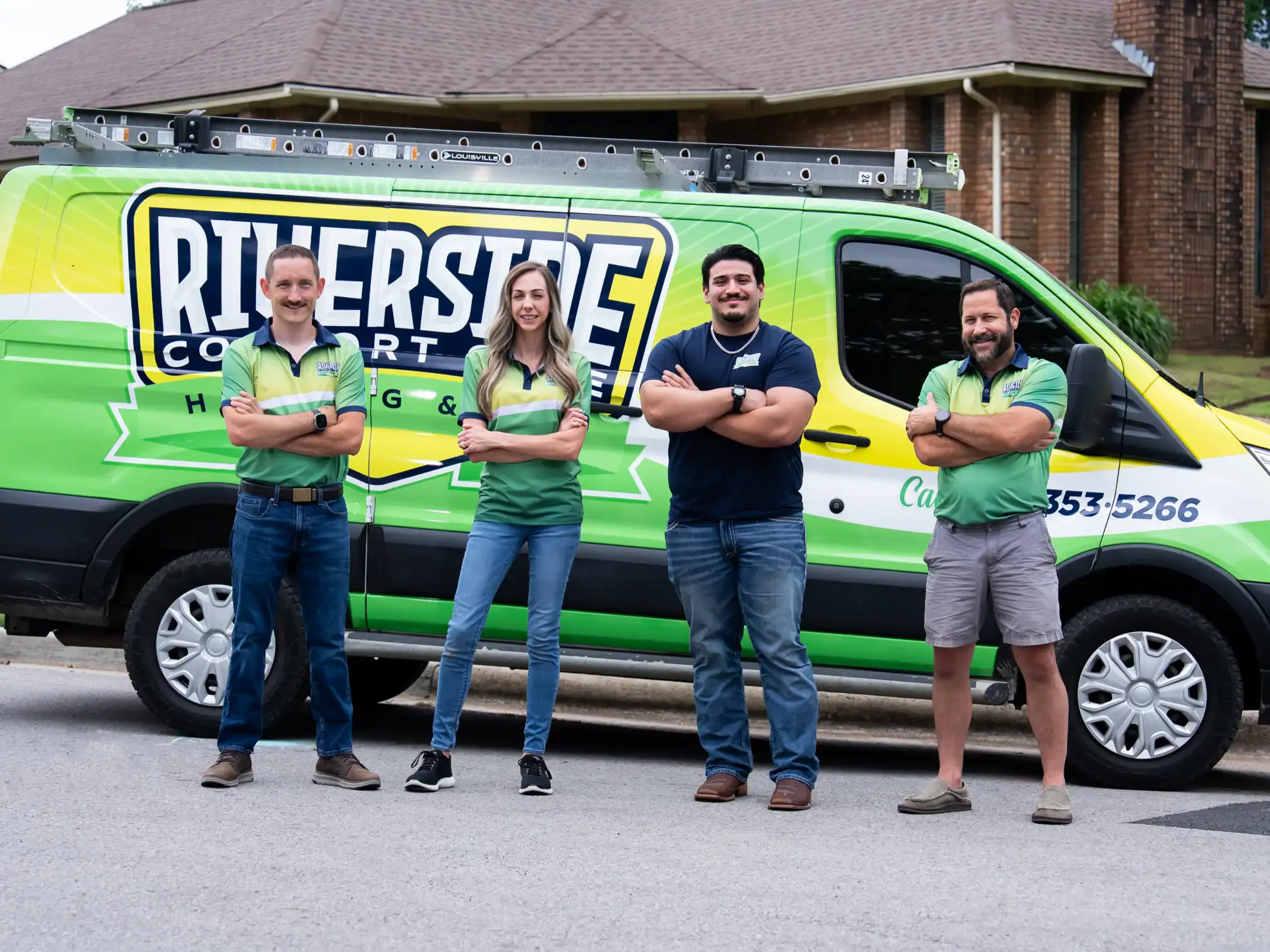 Riverside crew members in front of a company van