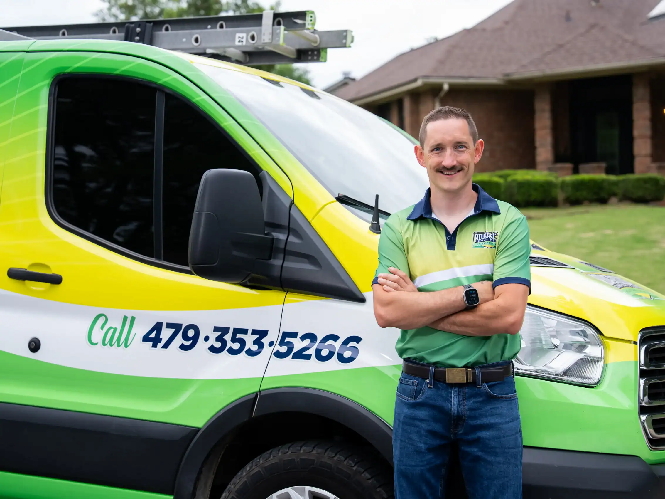 Riverside technician beside a service van with the office phone number