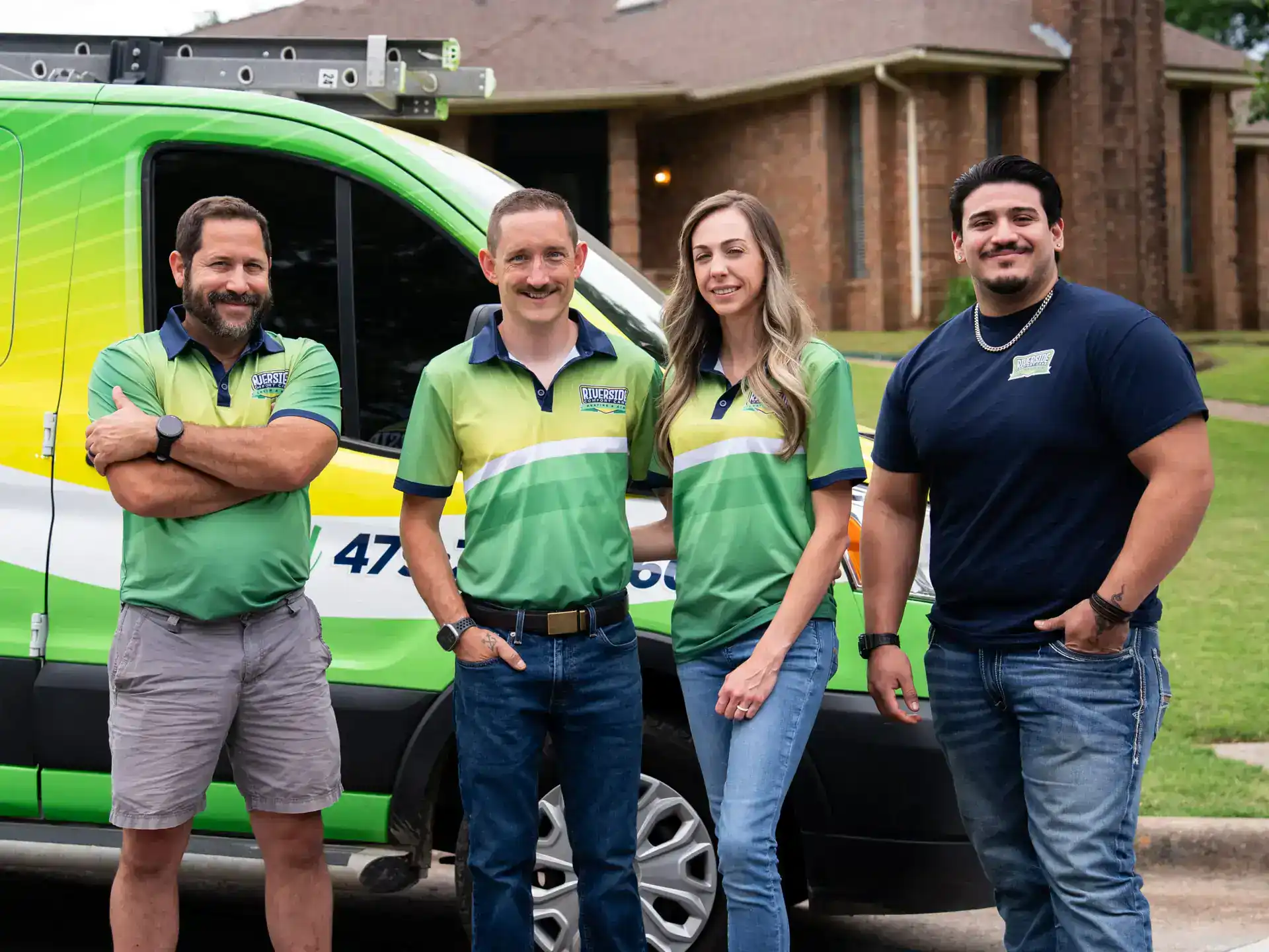 Riverside team members in front of a company van
