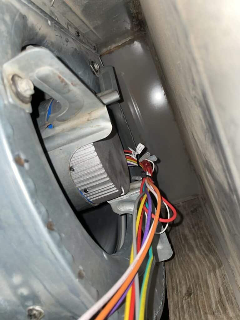 New blower motor mounted in the blower housing of a Booneville HVAC system