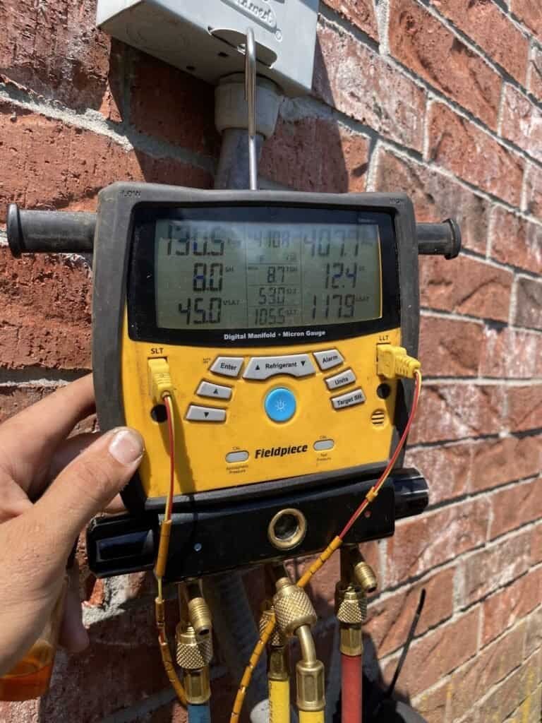 Digital refrigerant gauges used to check an air conditioner in Dyer, Arkansas