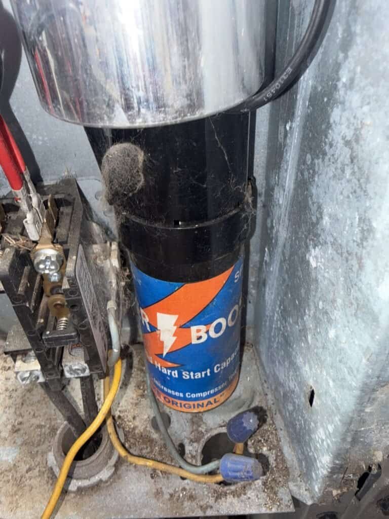 New capacitor installed next to the compressor in a Fort Smith outdoor AC unit