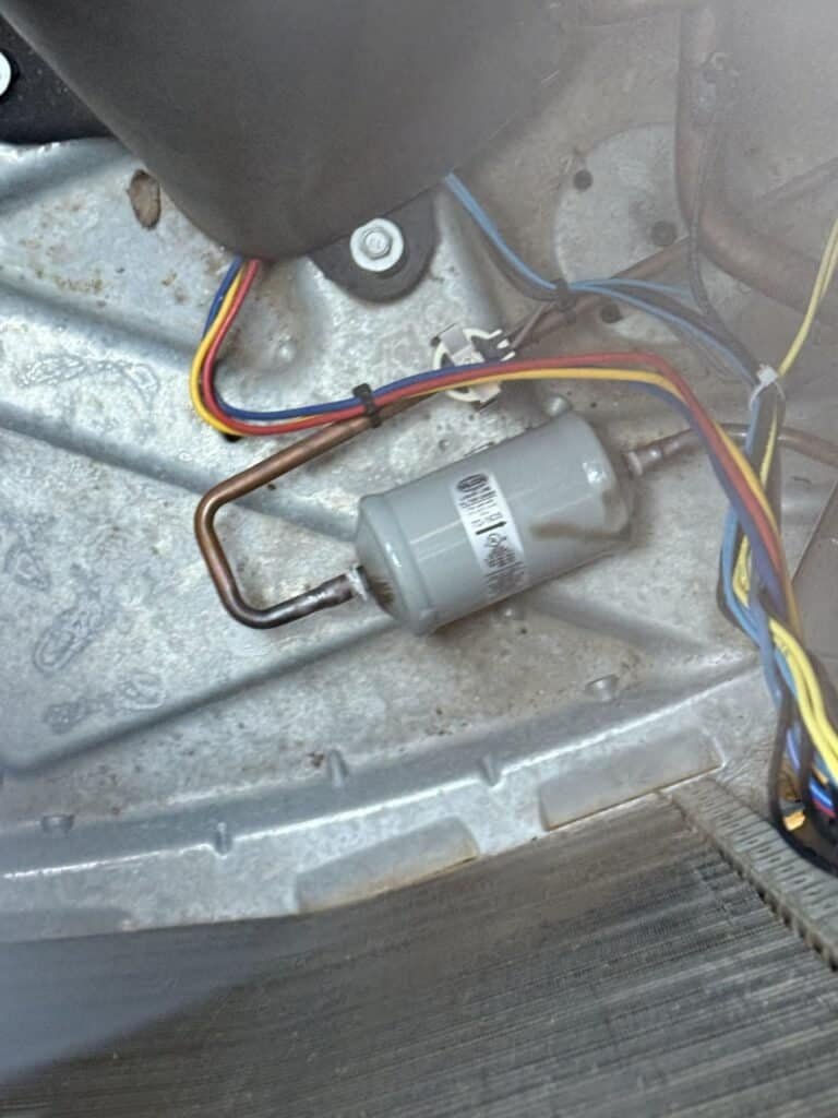Liquid line filter drier installed inside an outdoor AC unit in Fort Smith, Arkansas