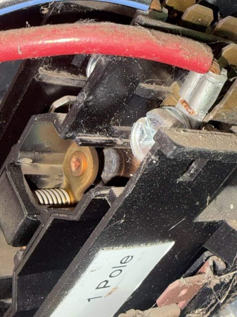 Close-up of a worn AC contactor with discolored contact points in a Fort Smith outdoor unit
