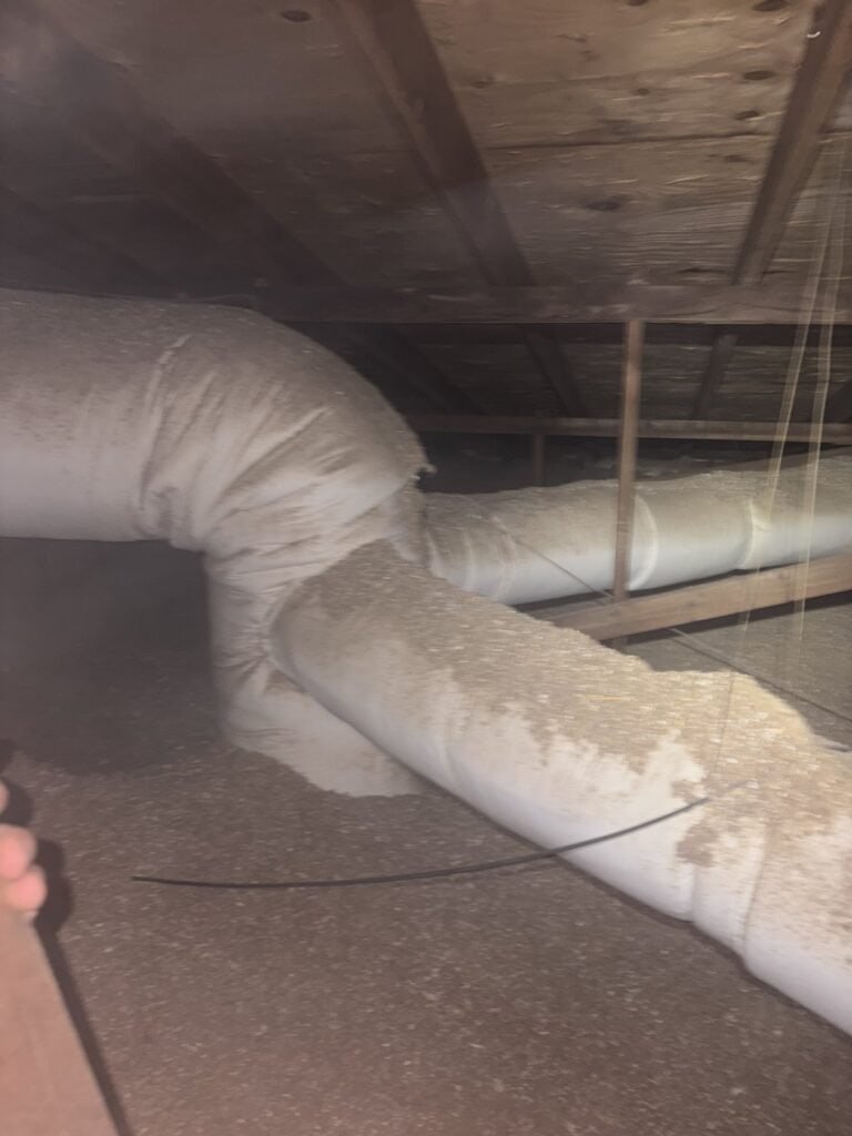 Insulated flexible ductwork in a Fort Smith attic, checked during an AC tune-up
