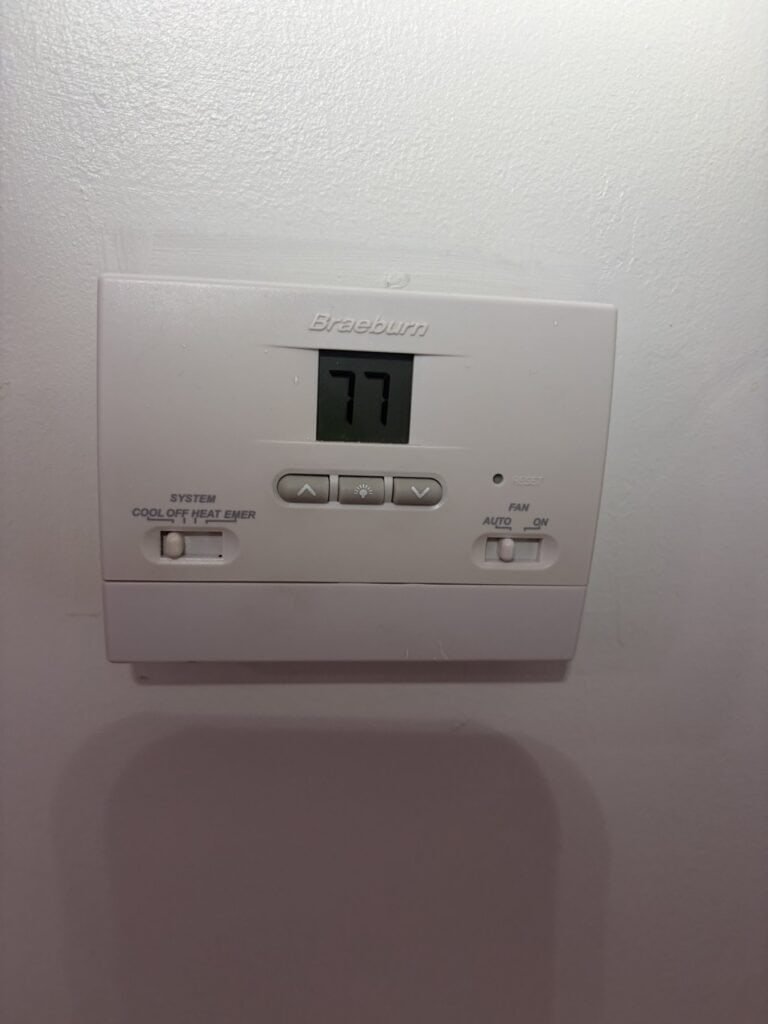 Wall thermostat at a Fort Smith home during a fall AC tune-up