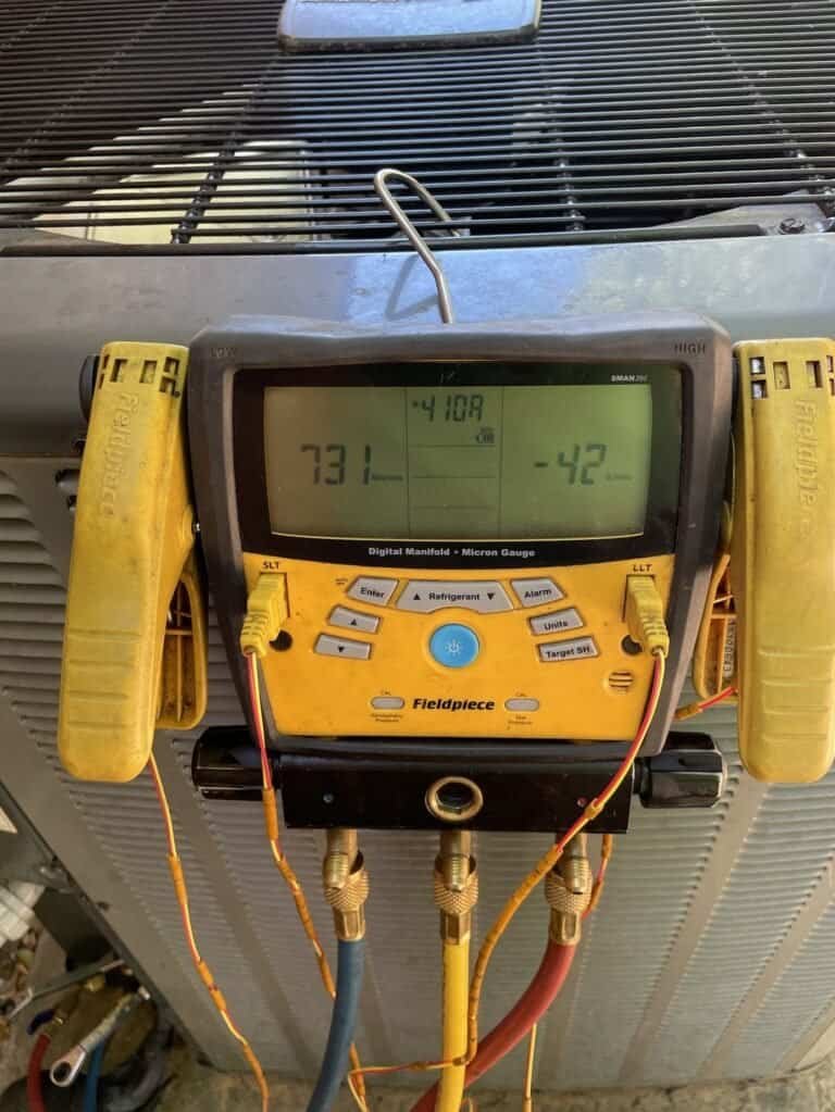 Digital gauges in vacuum mode connected to a Greenwood AC outdoor unit after a leak repair
