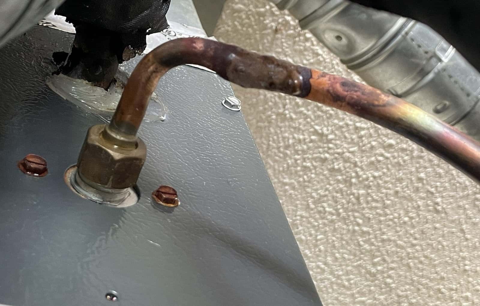Copper refrigerant line connection at the outdoor unit of a Greenwood air conditioner