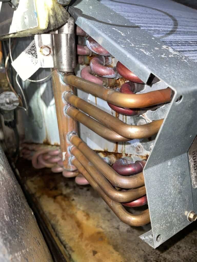 Copper refrigerant tubing on the indoor coil of a heat pump in a Greenwood home