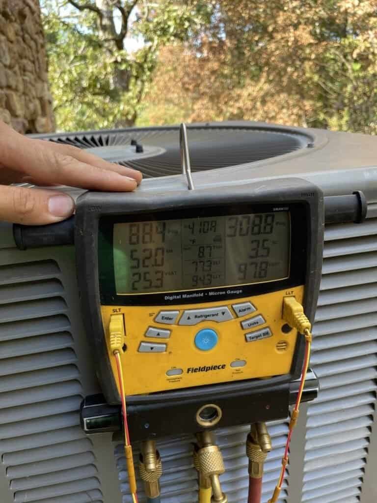 Digital refrigerant gauges connected to a heat pump outdoor unit in Greenwood, Arkansas