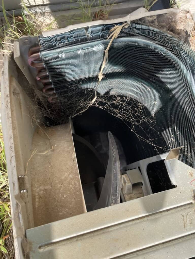 Top of an outdoor AC unit removed to reach the inside of the coil during a Hackett tune-up