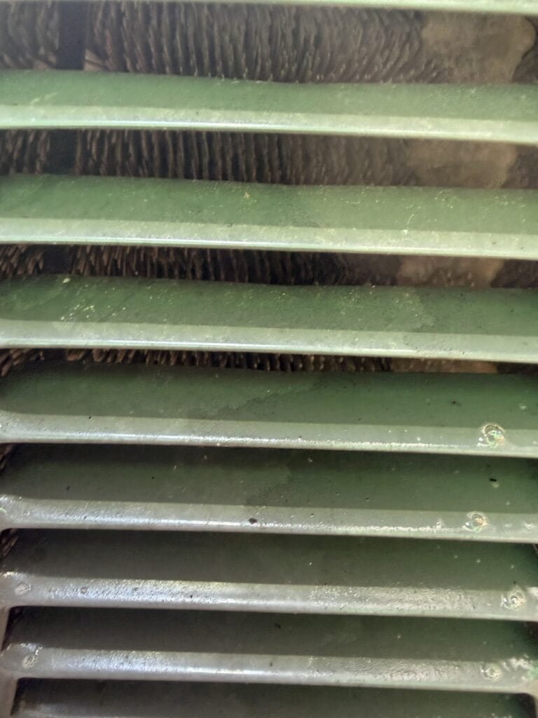 AC condenser coil seen through the louvers after cleaning in Rudy