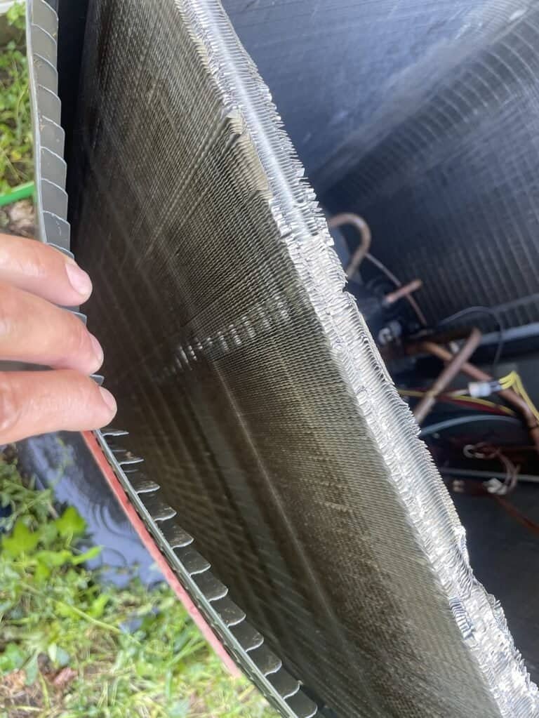 Outdoor AC coil opened up for cleaning at a Van Buren home