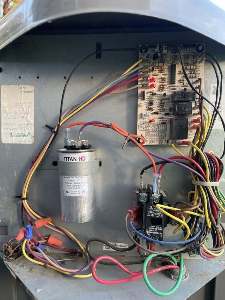 Replacement capacitor installed in the electrical compartment of a Van Buren heat pump