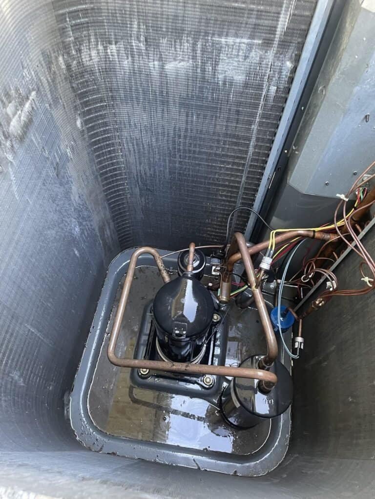 Outdoor AC unit with the fan and top removed for a deep cleaning in Van Buren, Arkansas