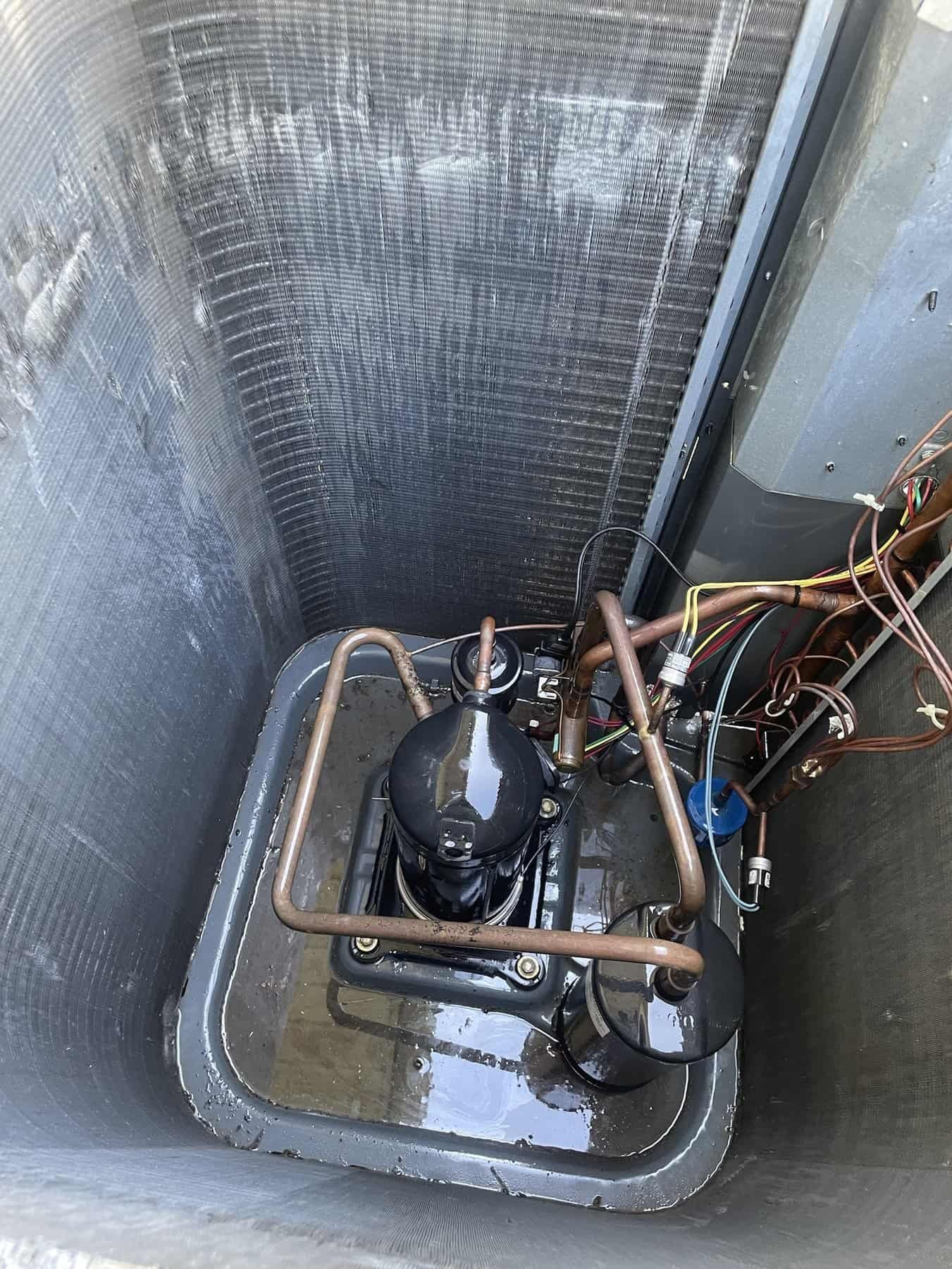 Outdoor AC unit with the fan and top removed for a deep cleaning in Van Buren, Arkansas