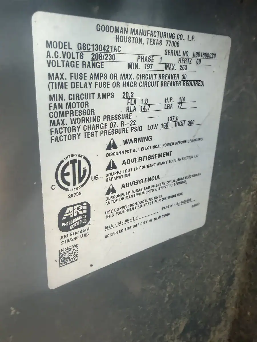 Model and serial number label on an outdoor AC unit at an Alma home
