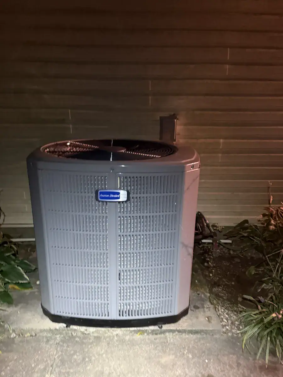 New American Standard outdoor AC unit on a pad beside an Alma home