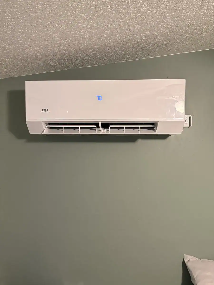 New ductless indoor unit mounted high on a wall in an Alma home
