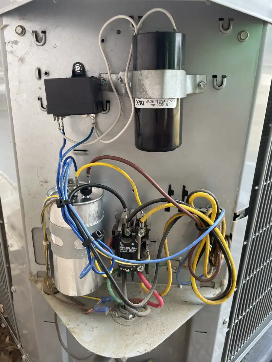 Capacitor (motor start part) and wiring inside a Fort Smith outdoor AC unit