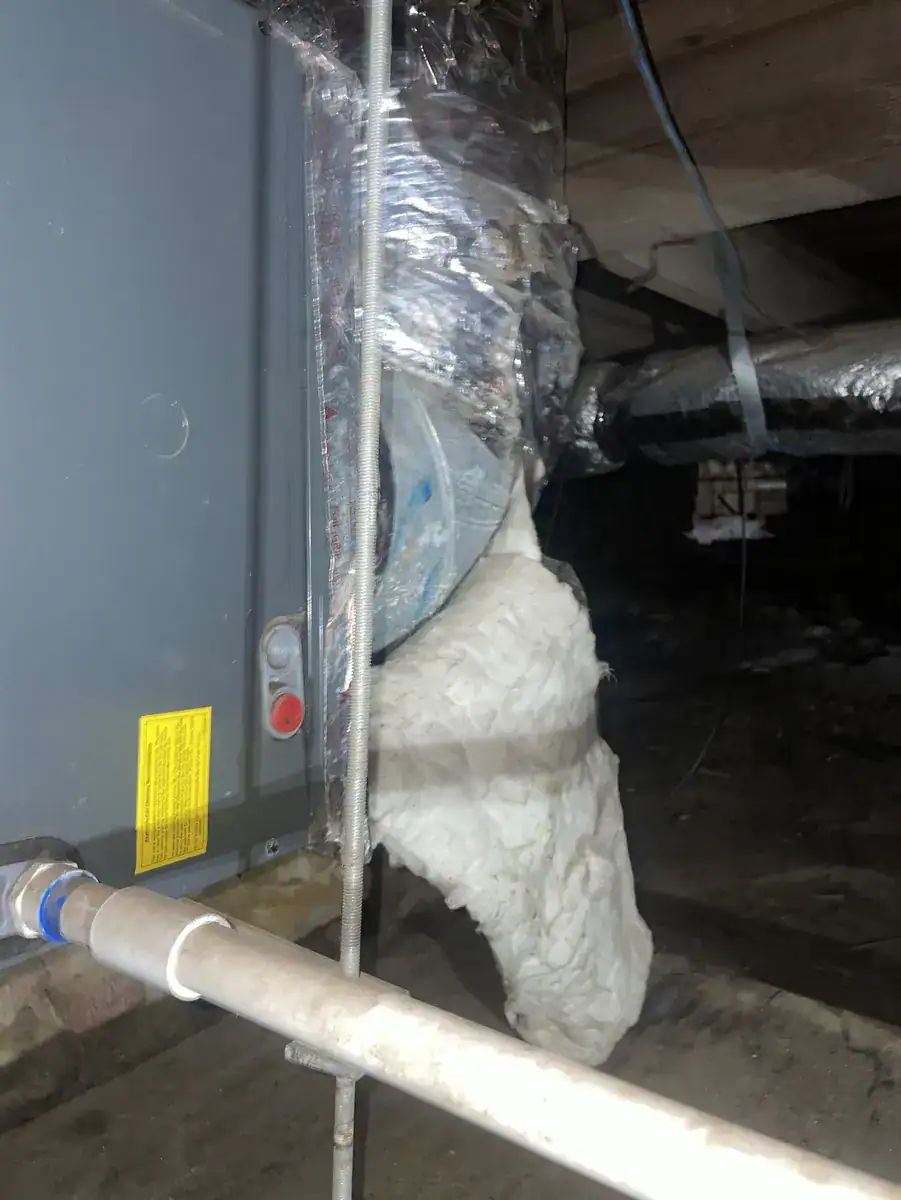 Furnace vent and drain pipes in a Fort Smith crawlspace
