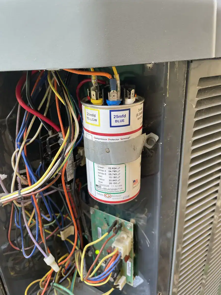 Wiring and a capacitor (motor start part) inside a Greenwood outdoor AC unit