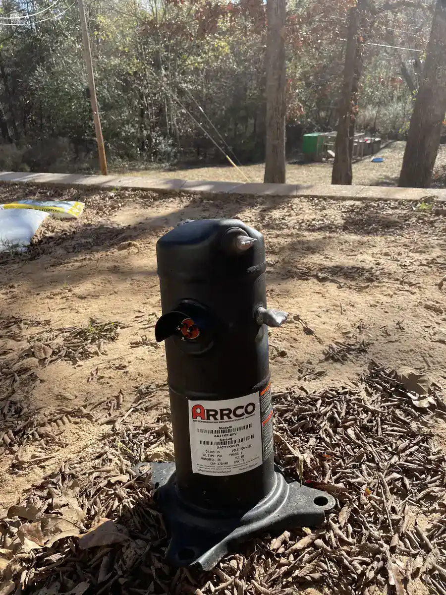 Old compressor removed from a Greenwood outdoor unit during a compressor replacement
