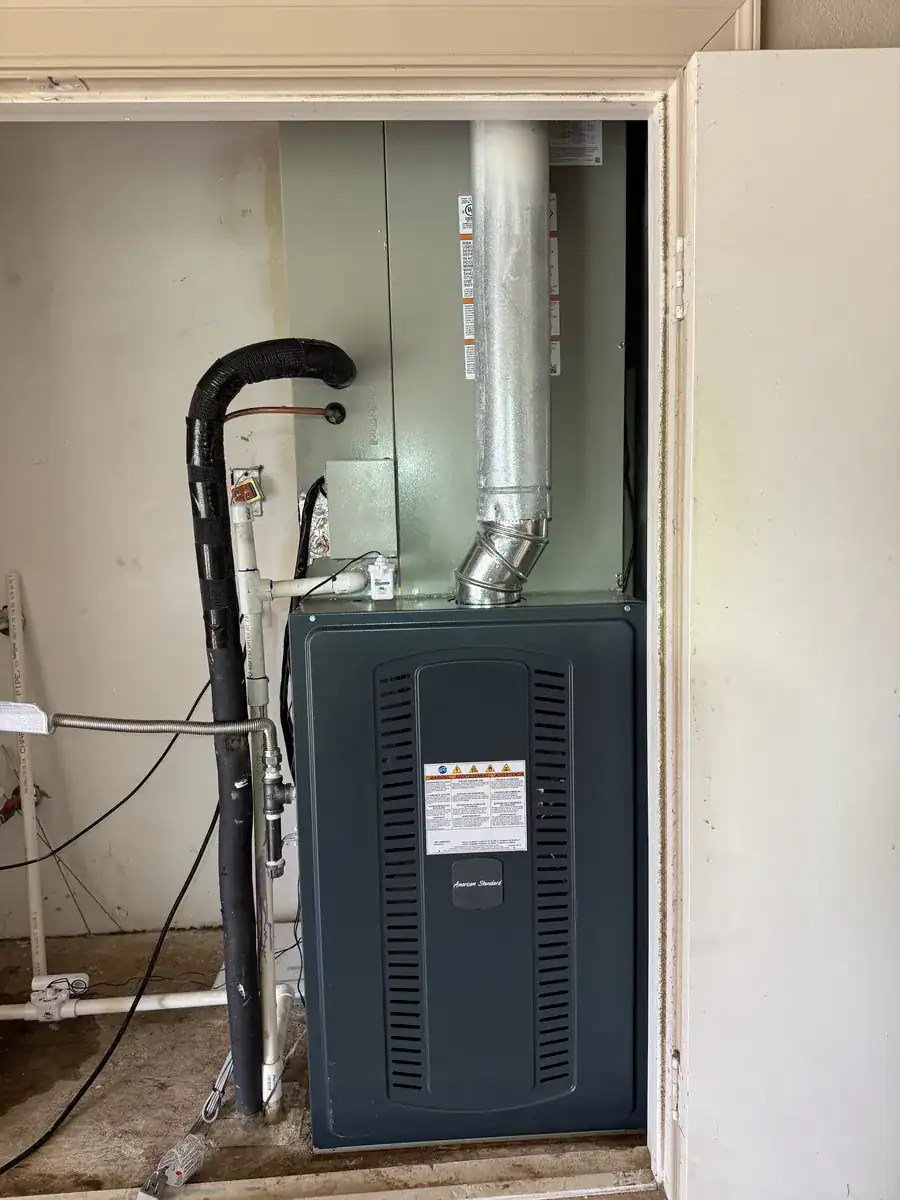 New gas furnace and cooling coil in an indoor closet in a Greenwood home