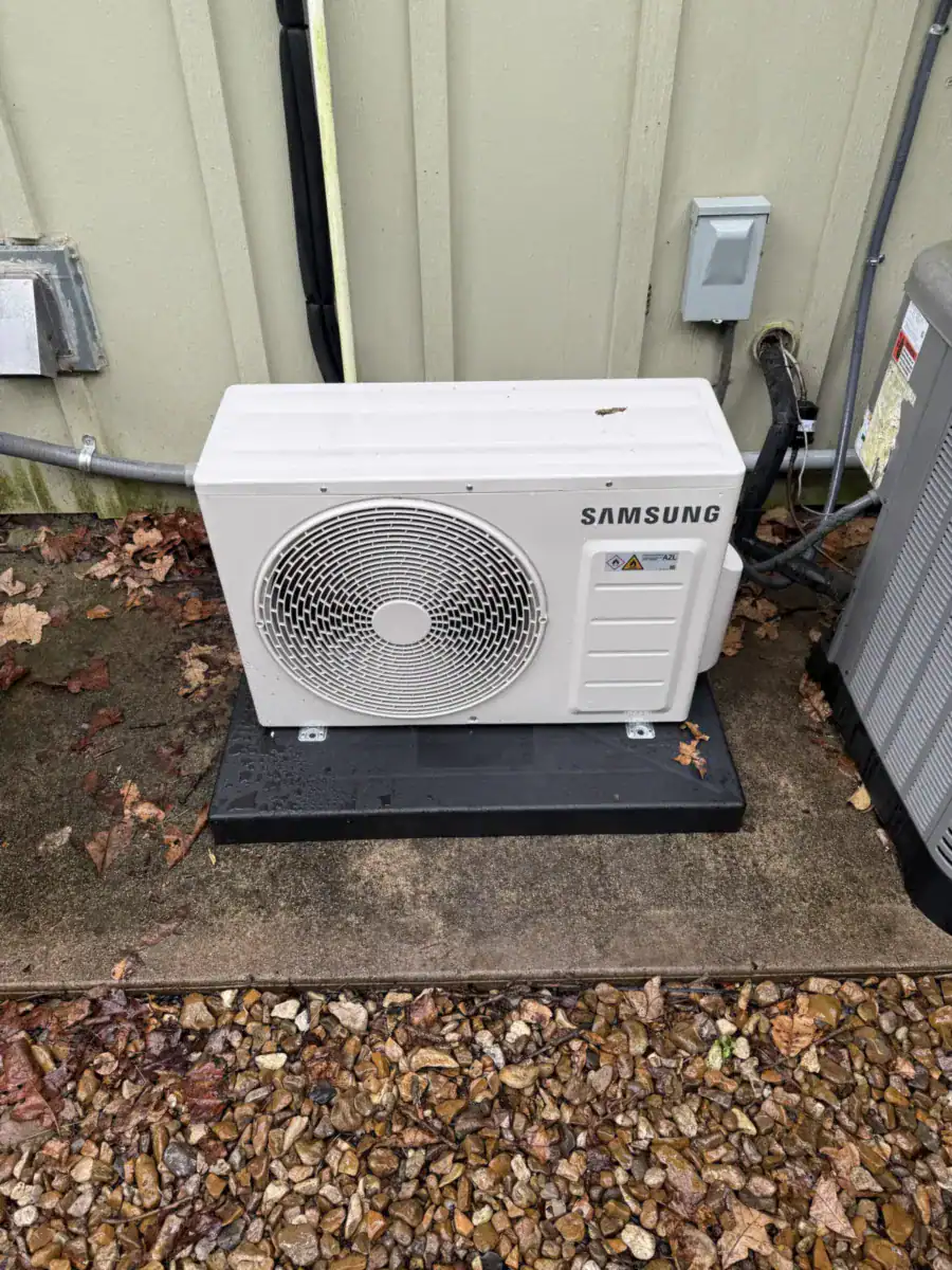 New ductless outdoor unit on a pad beside a Greenwood home