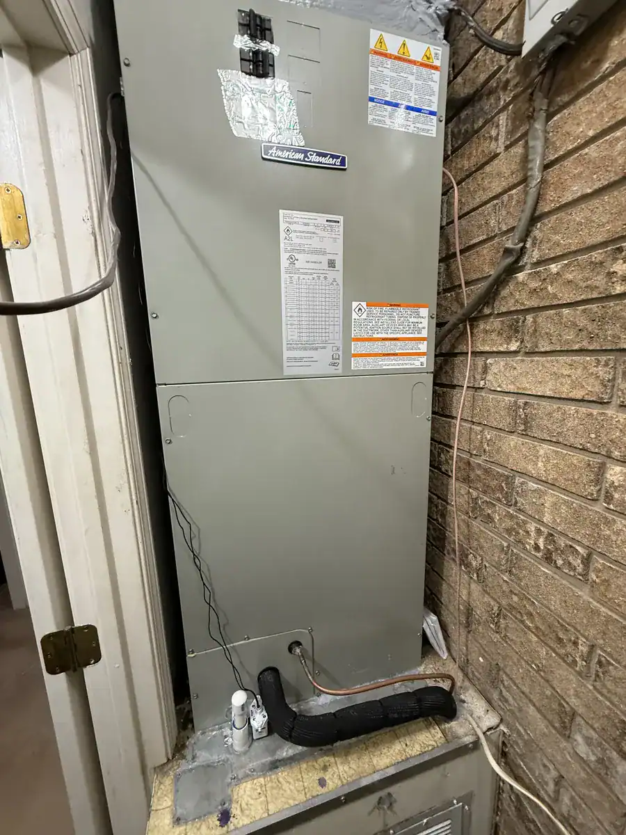 New American Standard air handler standing in an indoor closet
