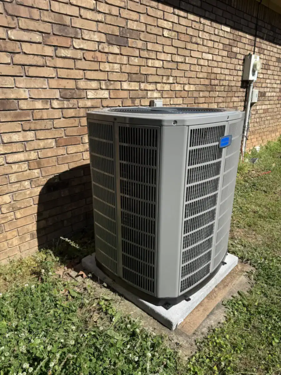 New American Standard outdoor AC unit on a pad beside a Van Buren home