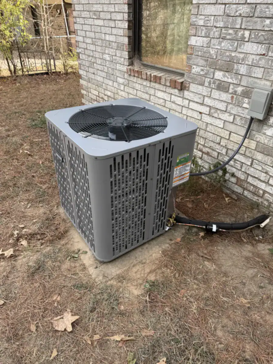 New heat pump outdoor unit on a slab beside a Van Buren home